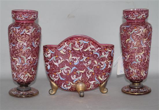 Three piece garniture of cranberry enamelled glassware